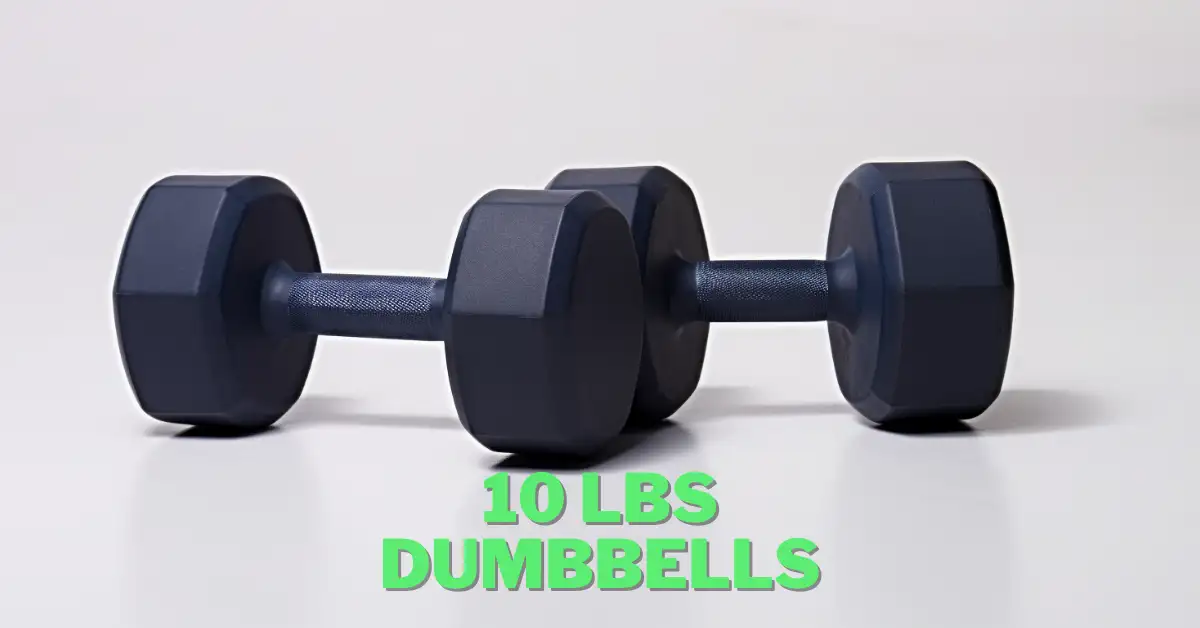 10 lbs dumbbells laying on the floor in front of white wall in studio light