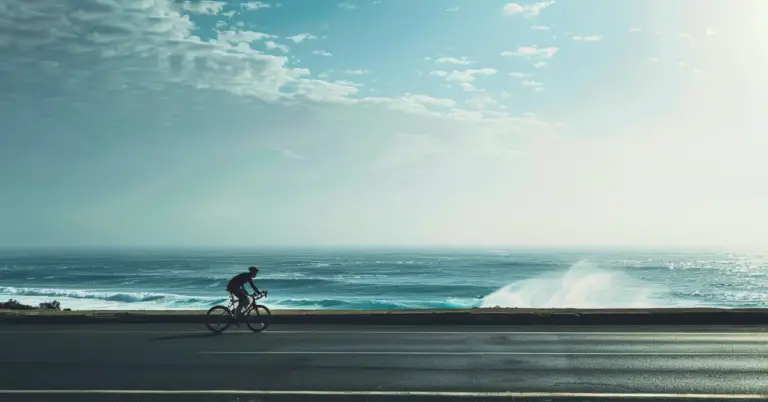 bike on the road with waves behind