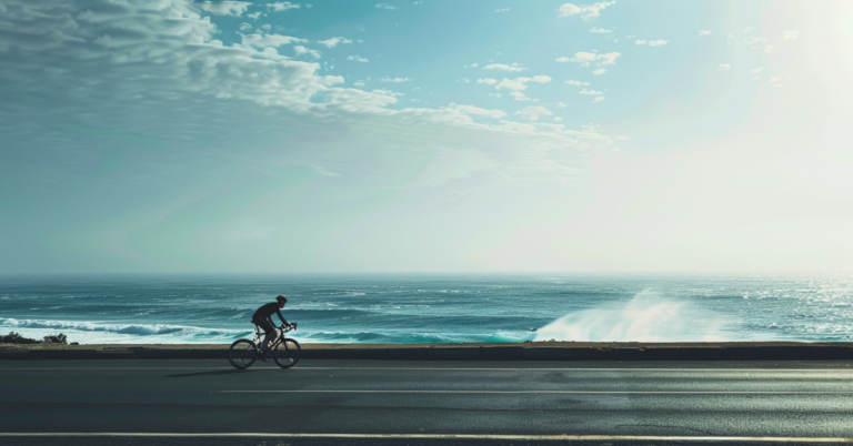 How to Become a Cycling Instructor: Your Career Guide 2024! 13 bike on the road with waves behind
